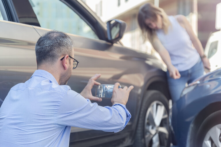 man taking picture at accident scene